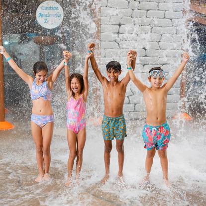 kids getting splashed at waterpark