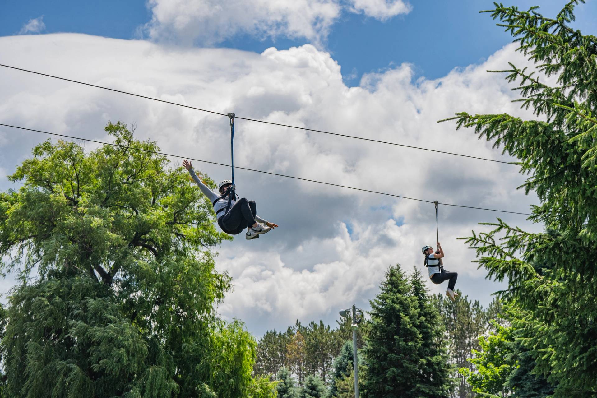 mom and daughter on twin zipline