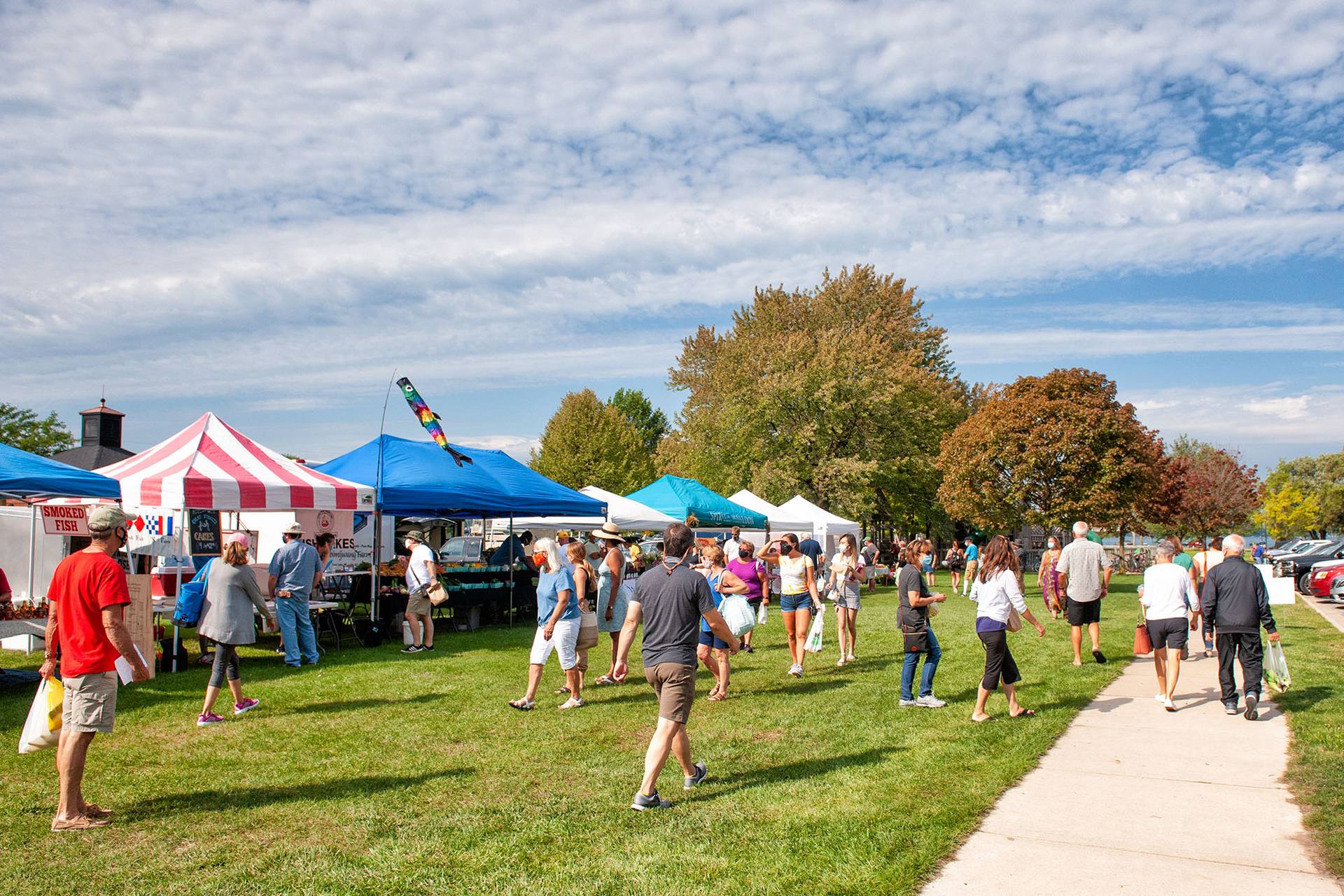 People walking around Boyne City's farmers market