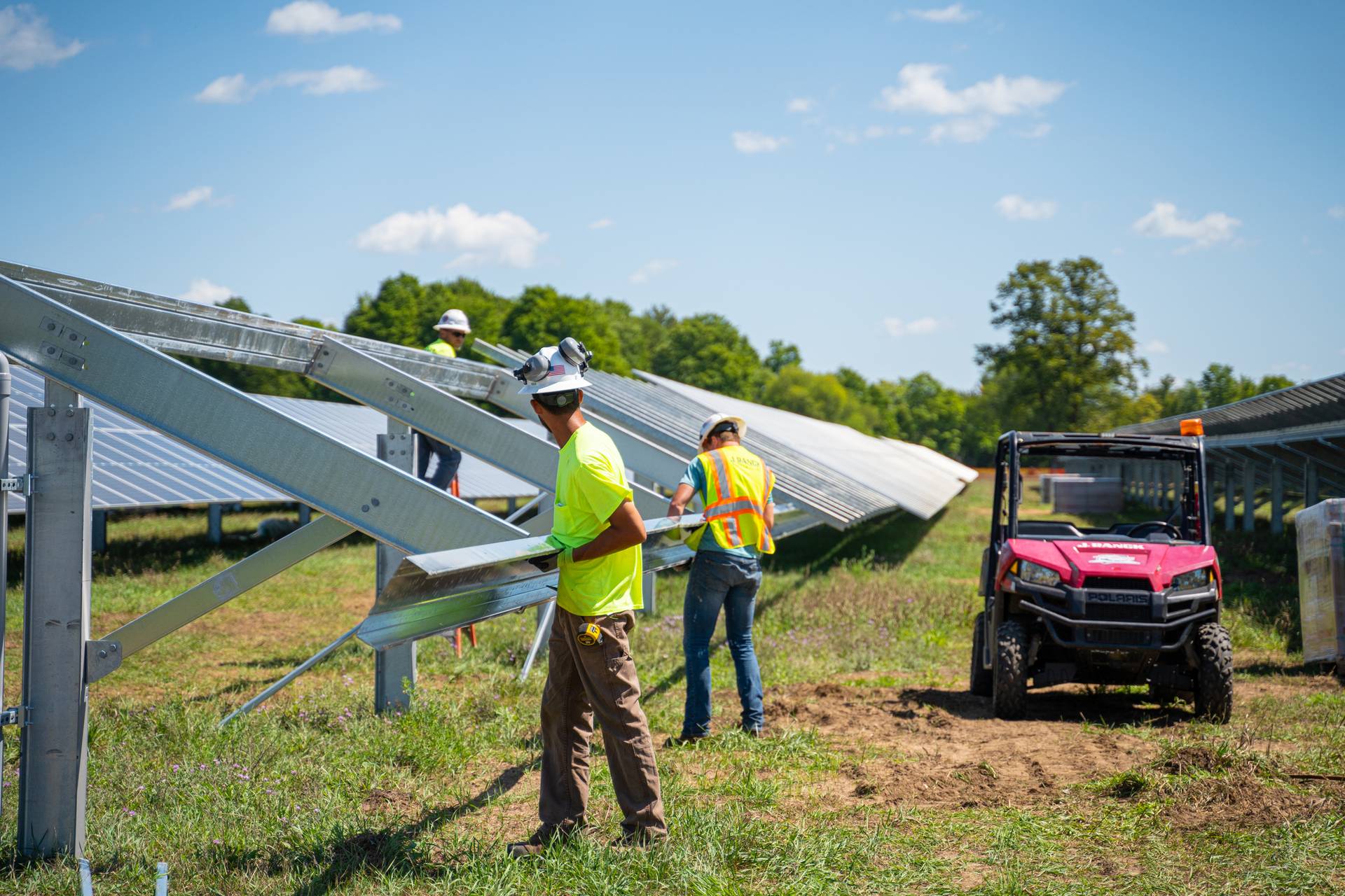 workers working on installing solar panels in the solar field