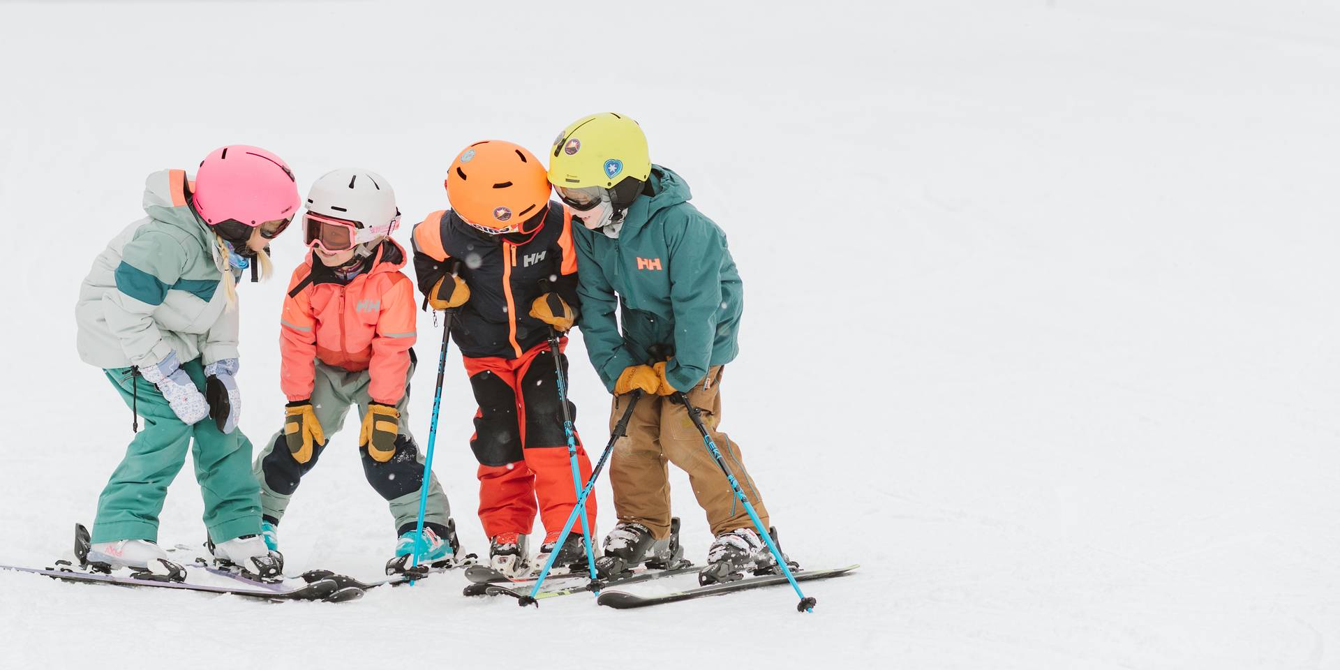 group of young kids on the slopes