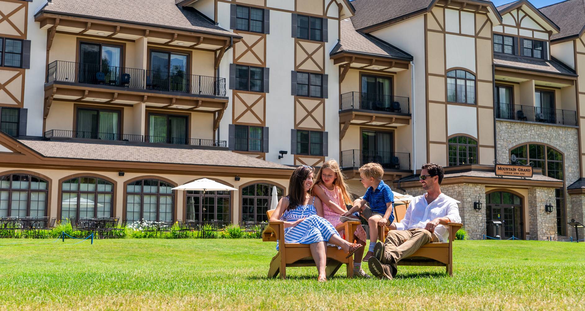 family sitting on the mountain grand lodge lawn