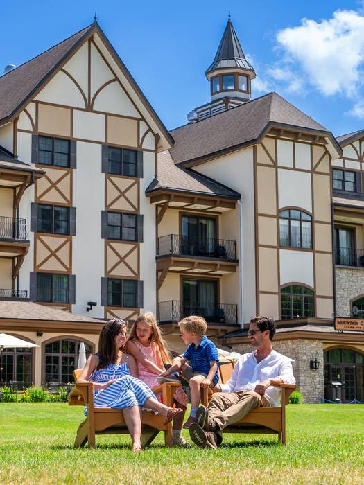 family sitting on mountain grand lodge lawn