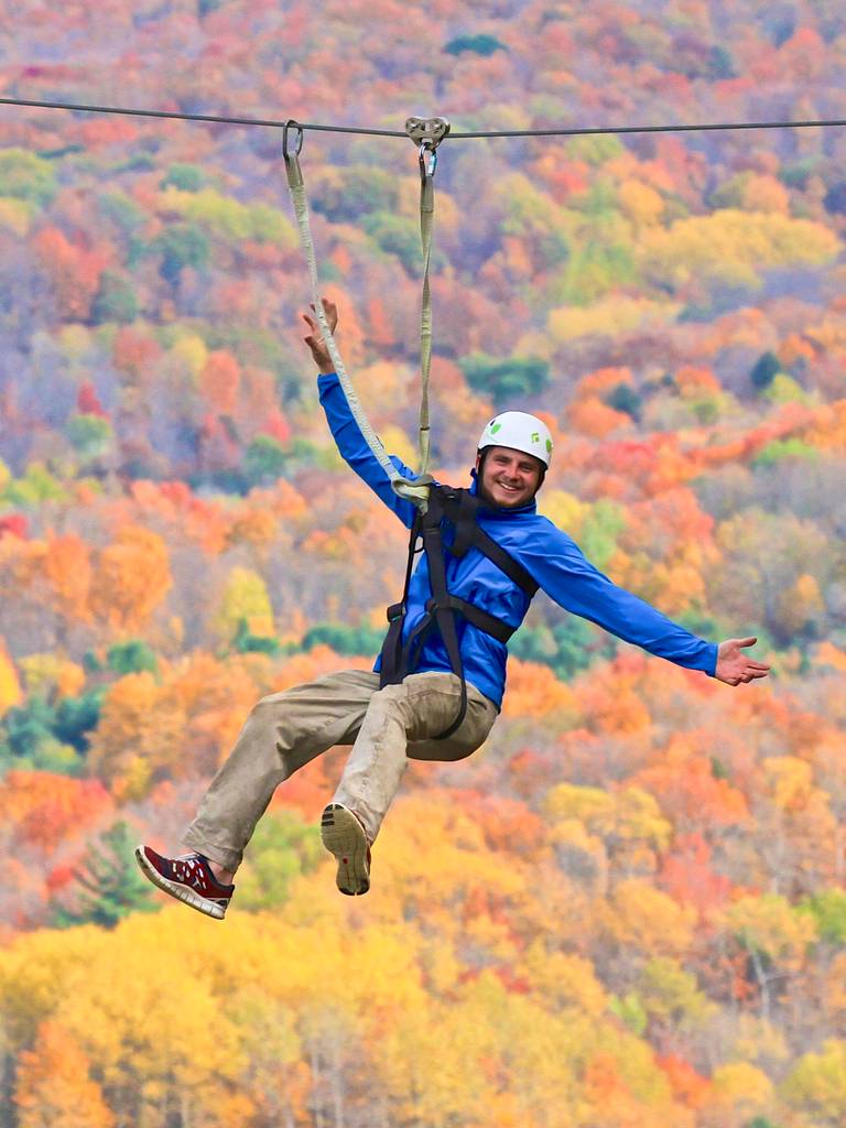 Man on the zipline during fall colors