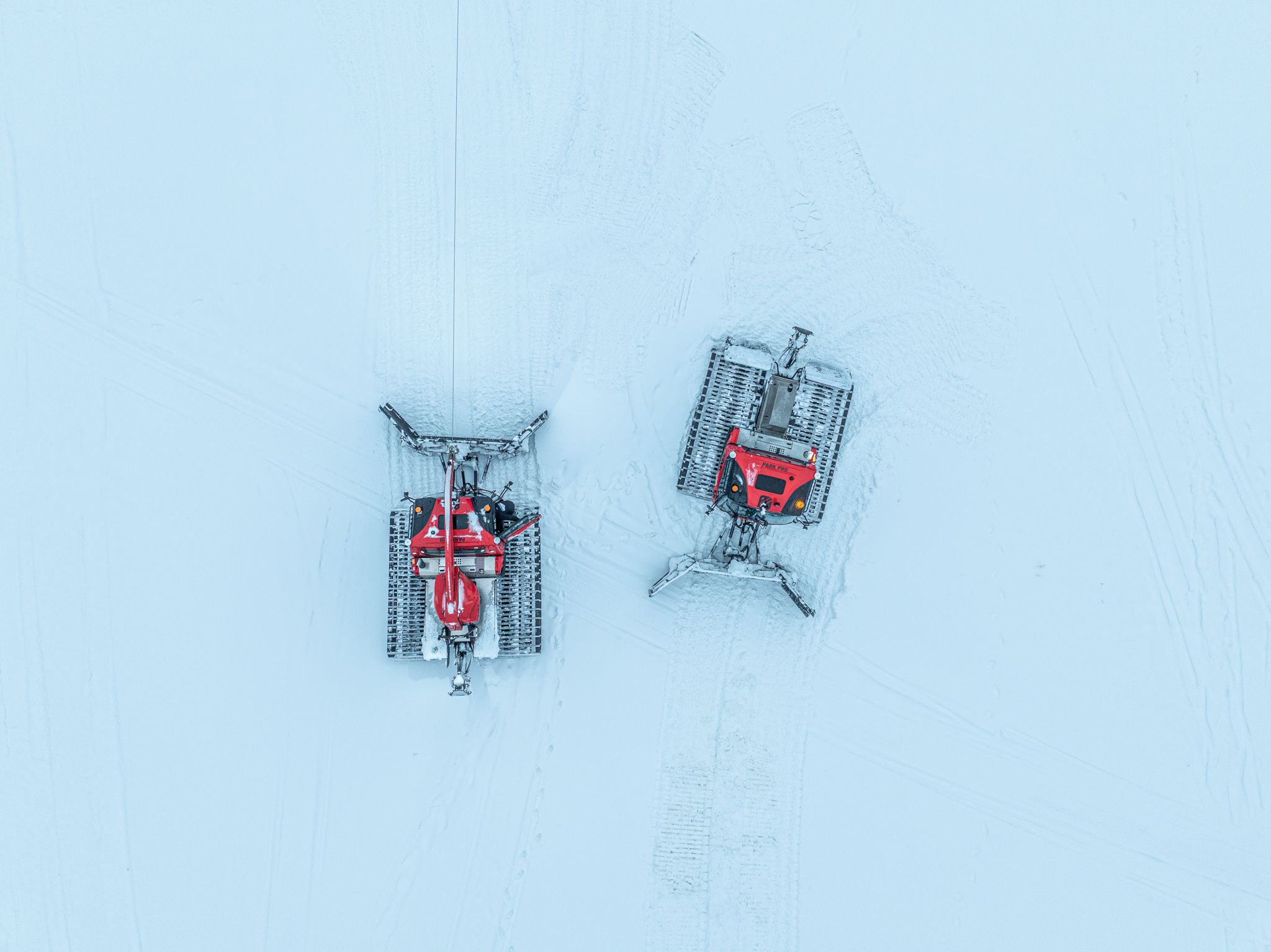 Two snow cats on the mountain