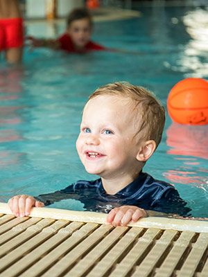 little boy in pool at waterpark
