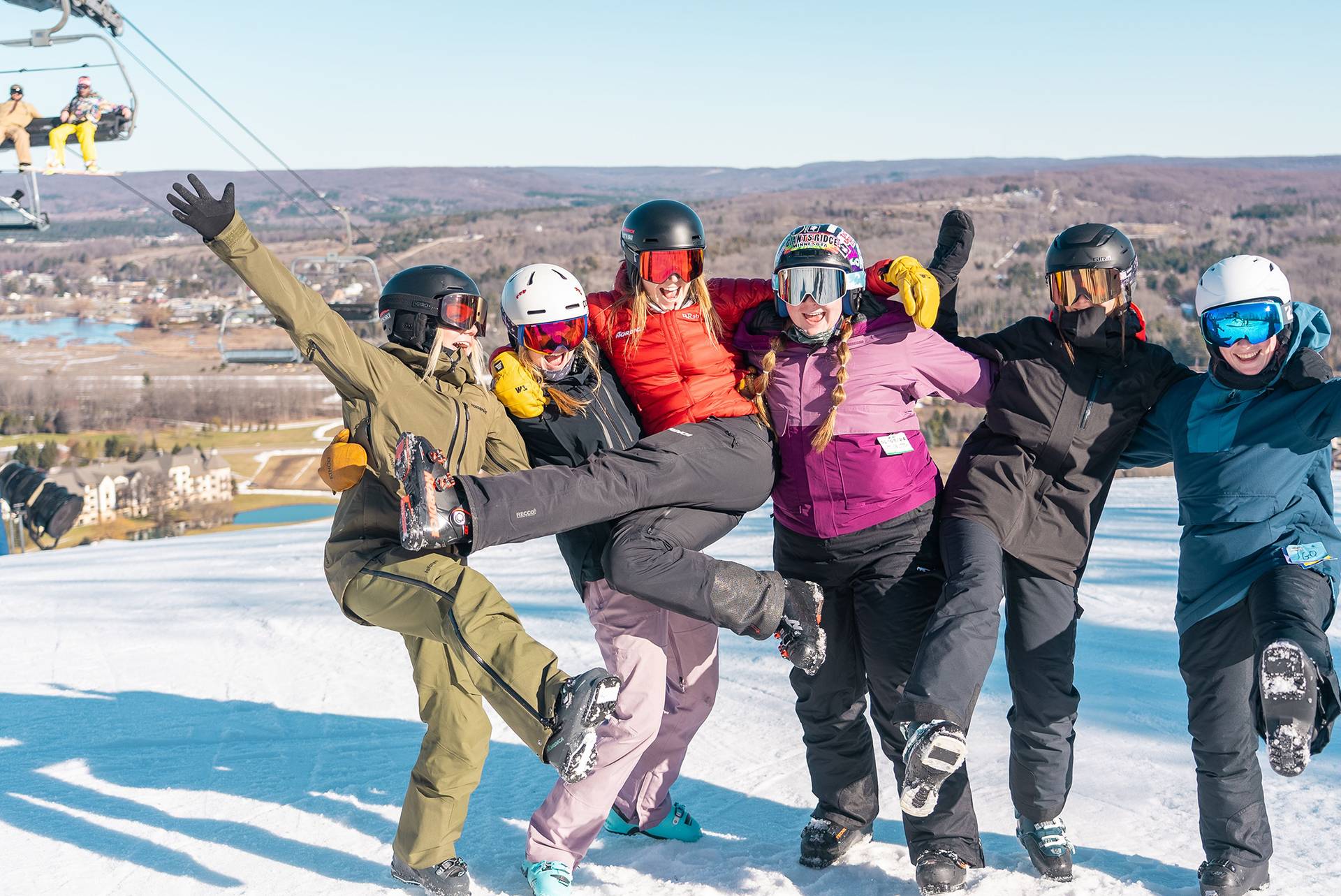 Group of Skiers at the top of the mountain posing for a photo
