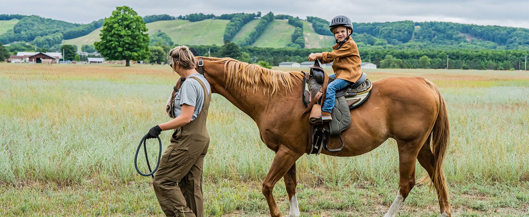 Child on a ride with guide walking