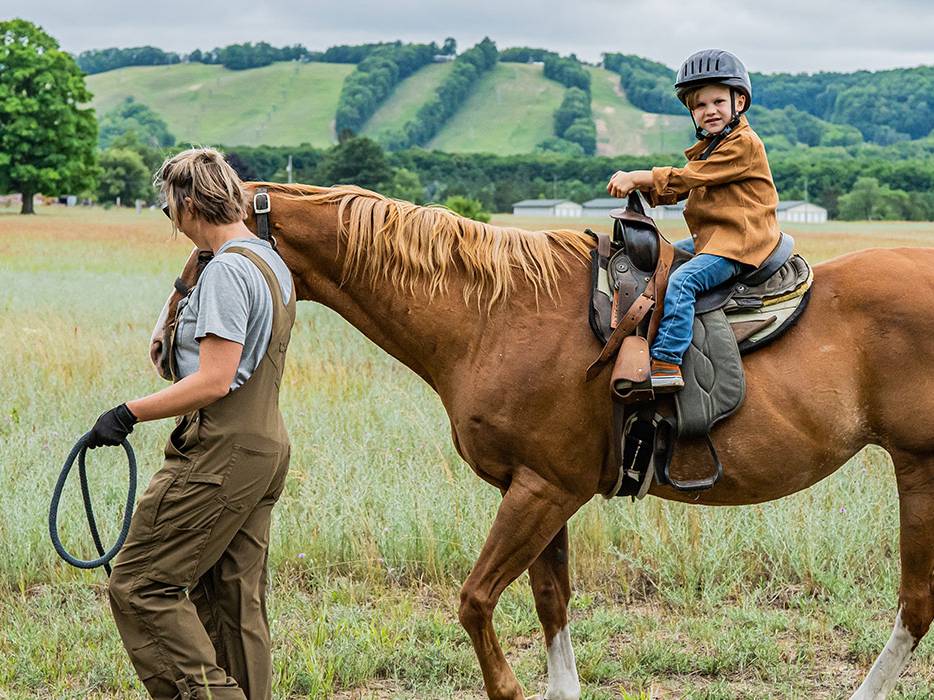 Child on a ride with guide walking