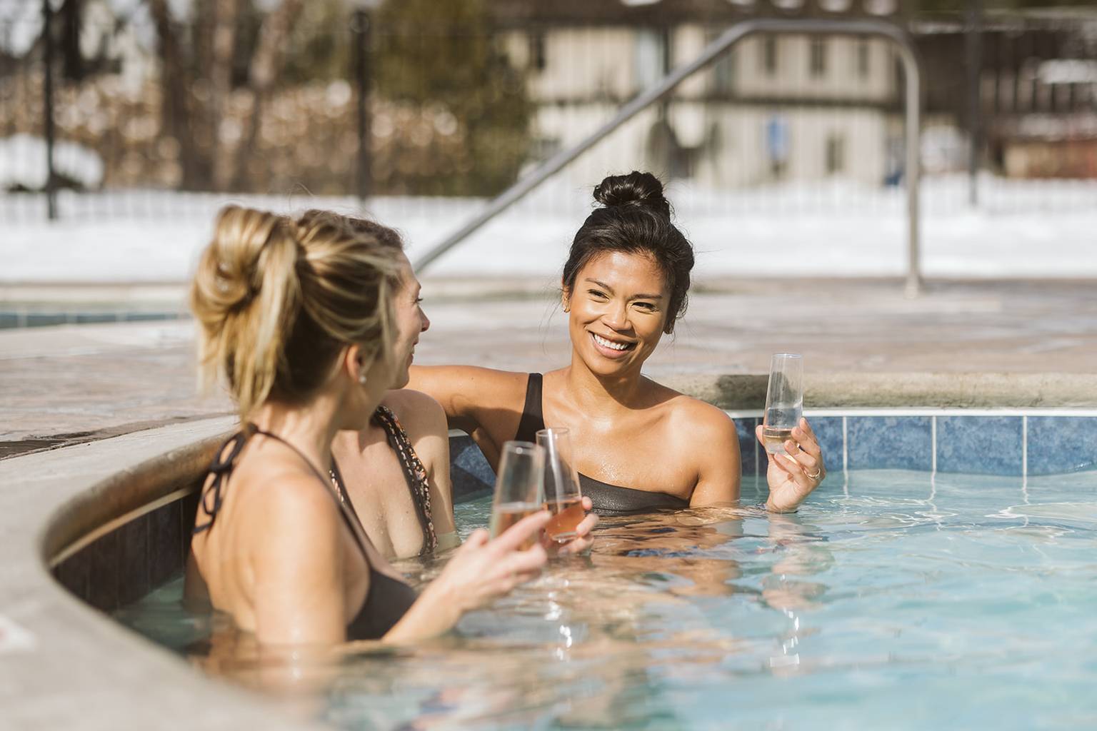 Ladies drinking champagne in the Mountain Grand Lodge and Spa hot tub.