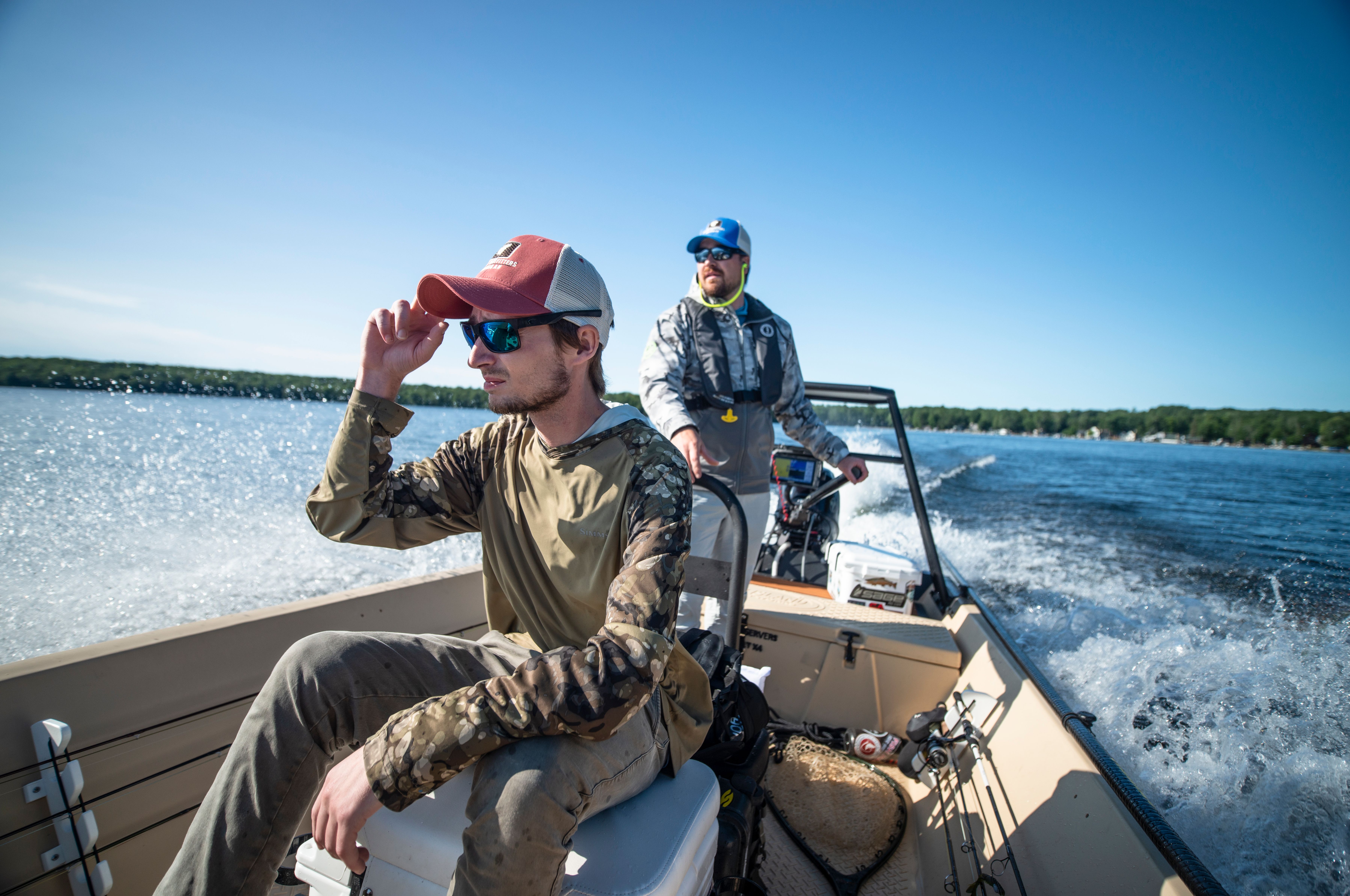 Fishermen driving a boat to their fishing spot on an inland lake.