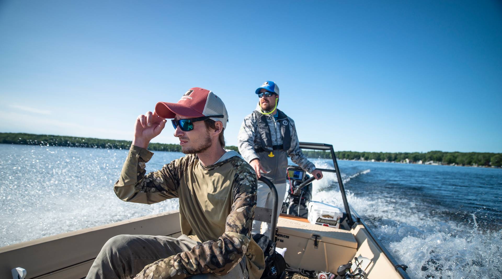 Fishermen driving a boat to their fishing spot on an inland lake.