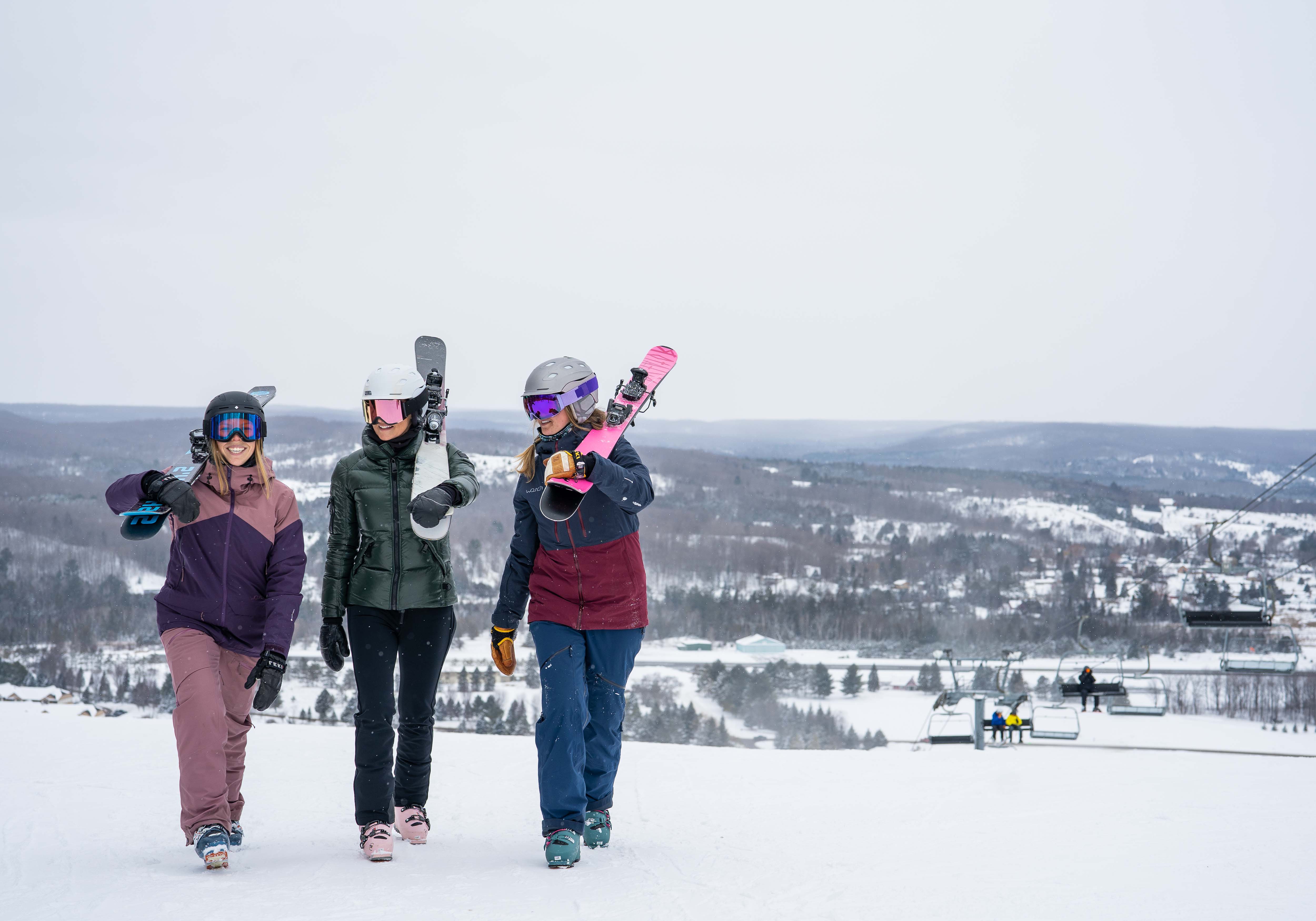 Skiers walking on hill