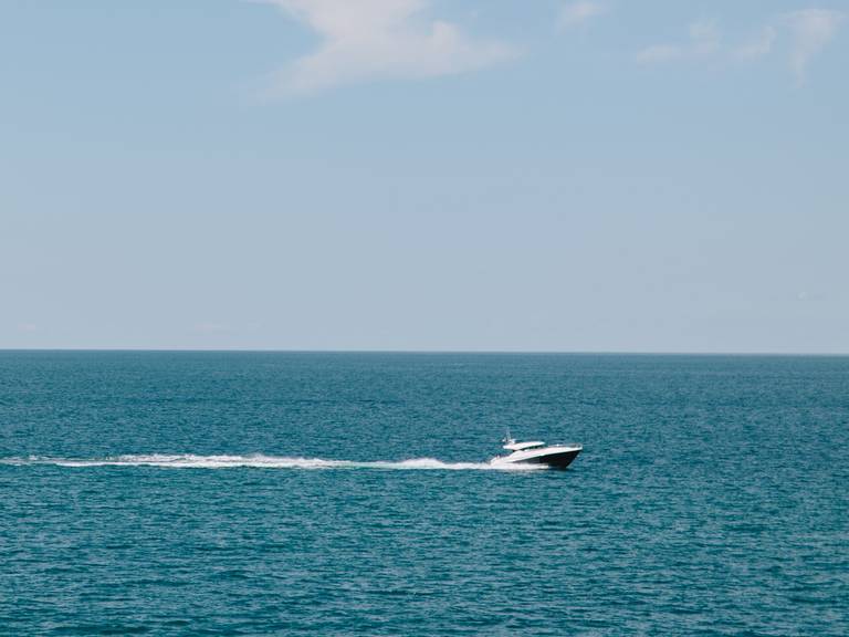 Boat on blue water, Little Traverse Bay