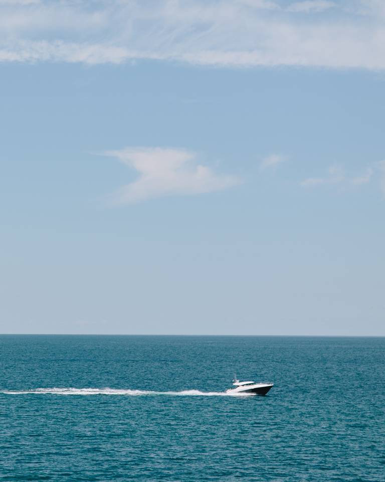Power boat driving on Little Traverse Bay