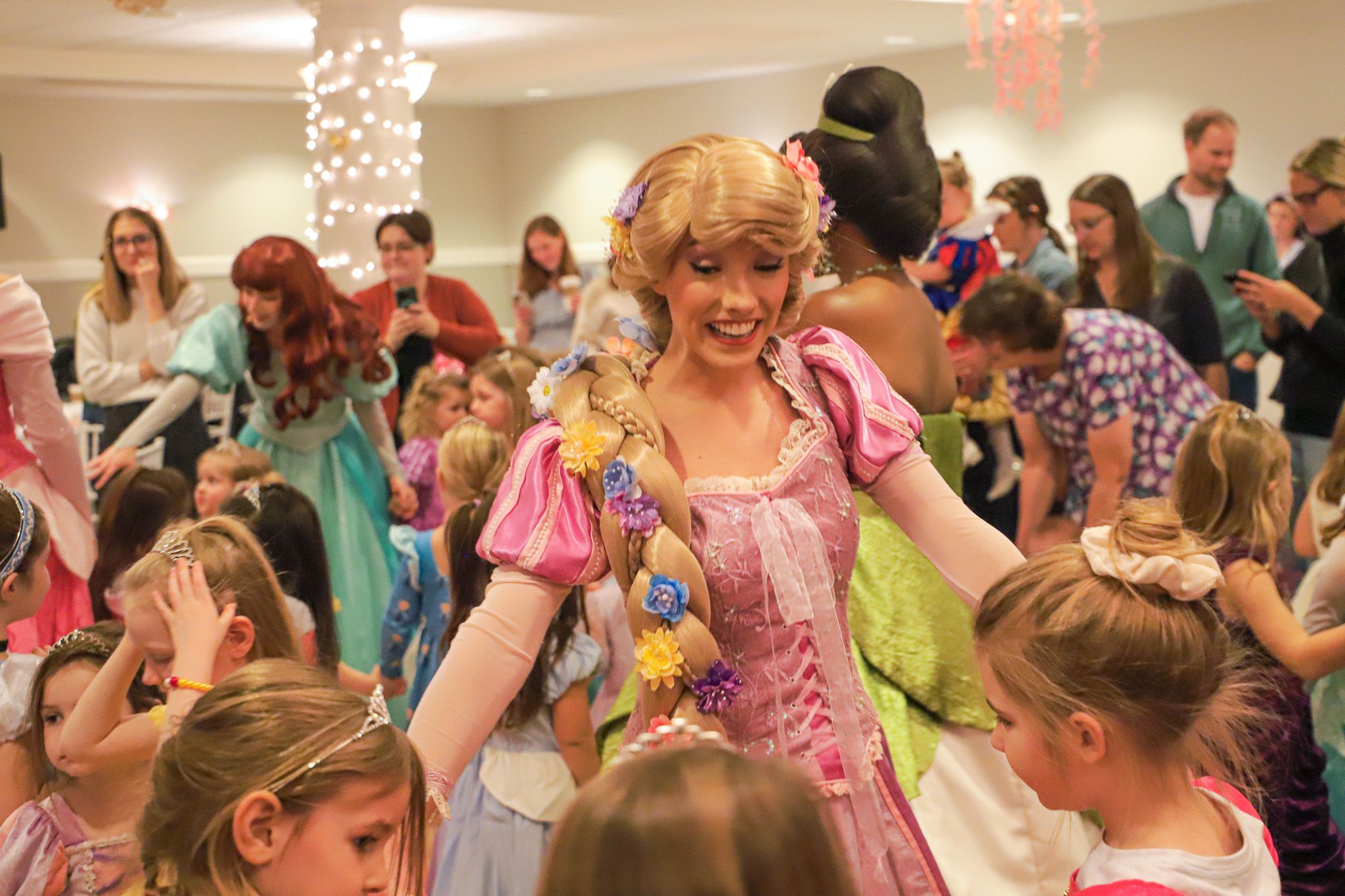 Rapunzel character smiling while dancing with Princess Gala guests, Inn at Bay Harbor