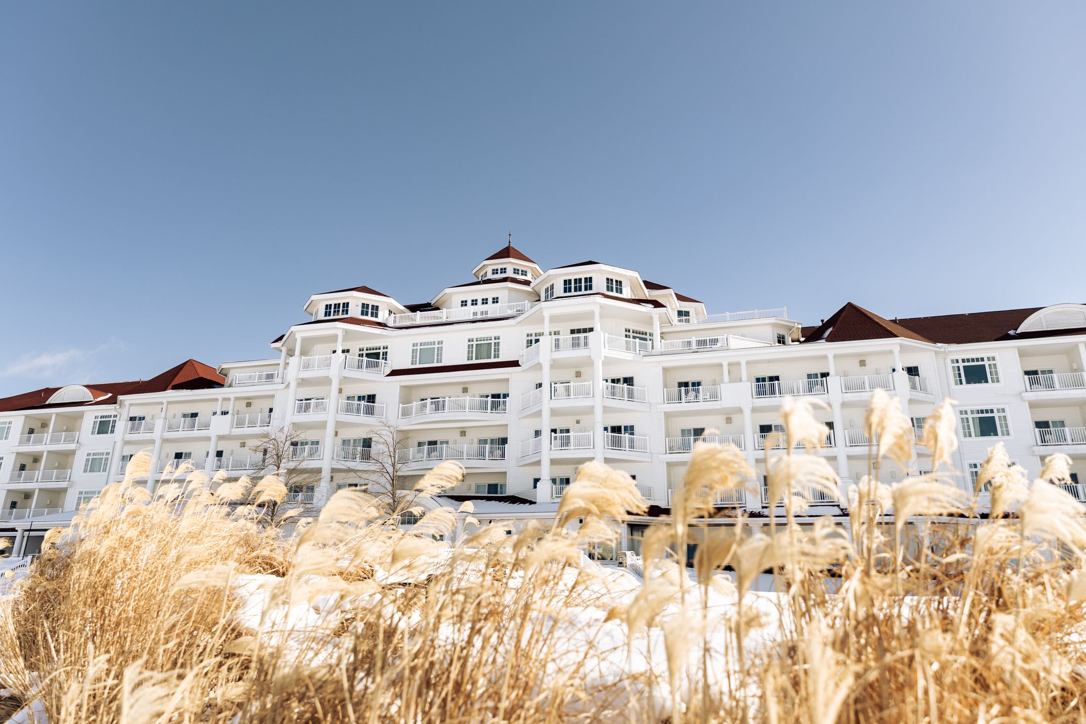 Inn at Bay Harbor winter facade with brown dune grass under blue sky