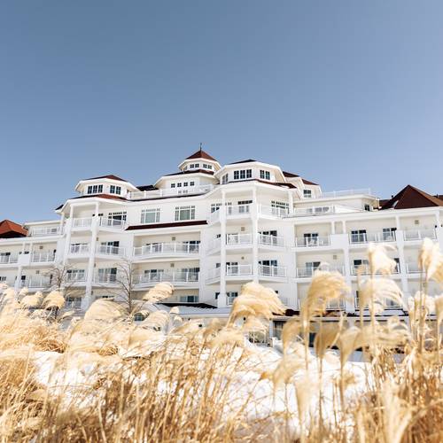 Inn at Bay Harbor winter facade with brown dune grass under blue sky