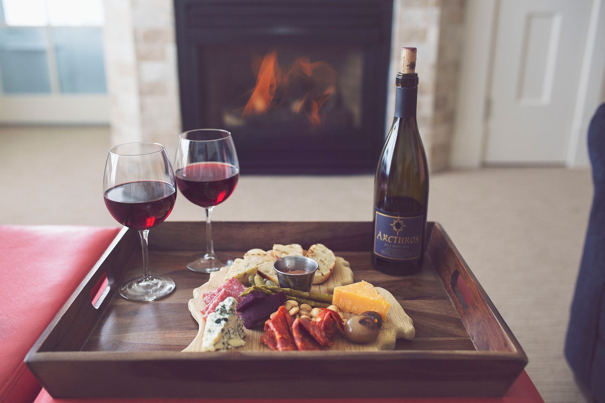 Red wine, charcuterie in front of fireplace