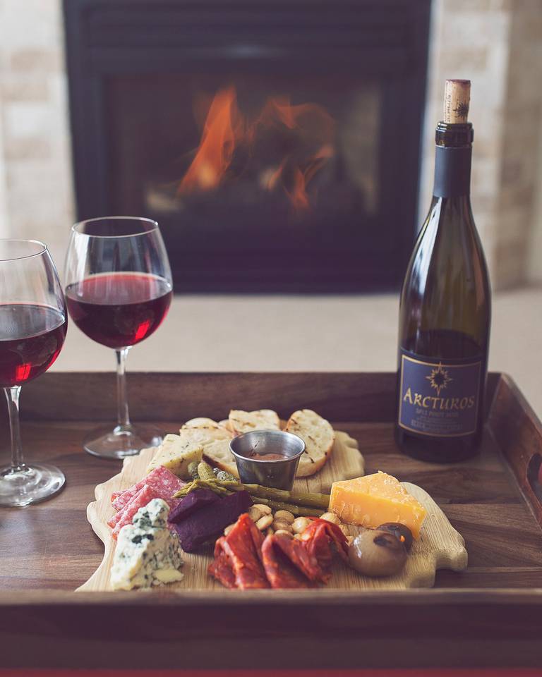 Red wine, charcuterie in front of fireplace