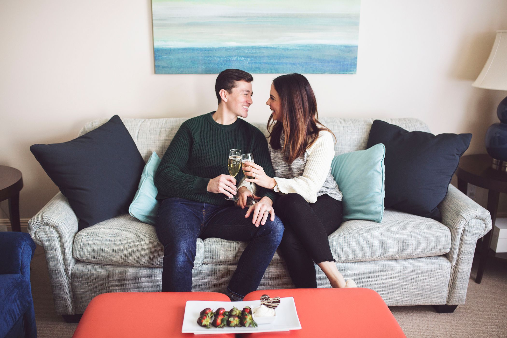 Couple toasts champagne with chocolate strawberries, Inn at Bay Harbor