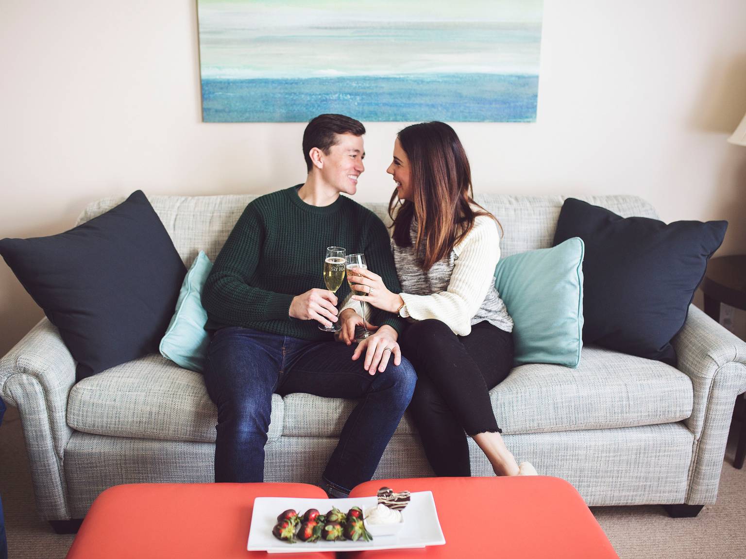 Couple toasts champagne with chocolate strawberries, Inn at Bay Harbor