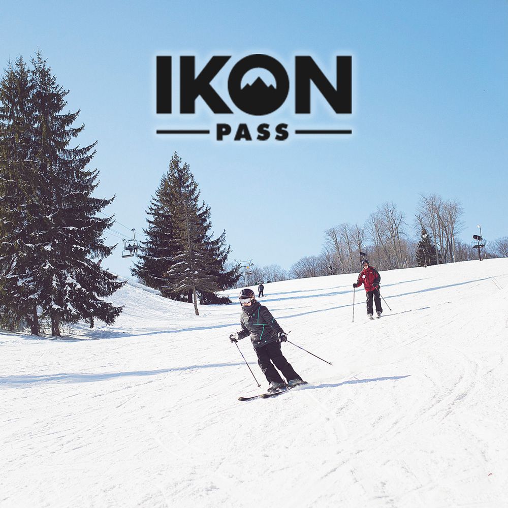 IKON Pass logo over skiers racing down snowy slopes on sunny winter day