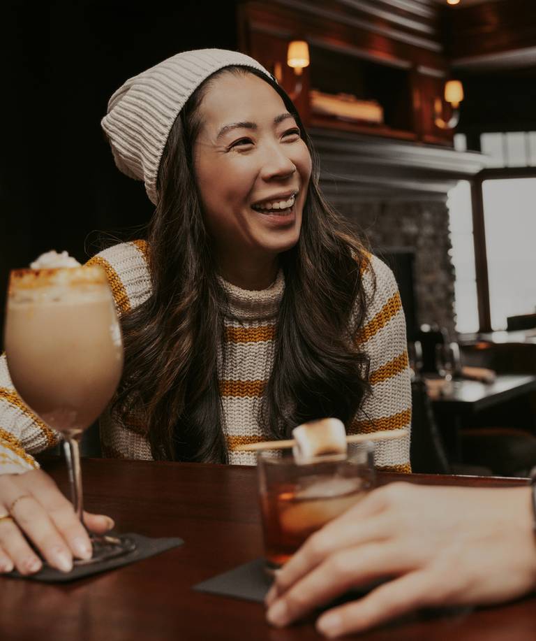 Woman laughing over cocktails, Vintage Chophouse