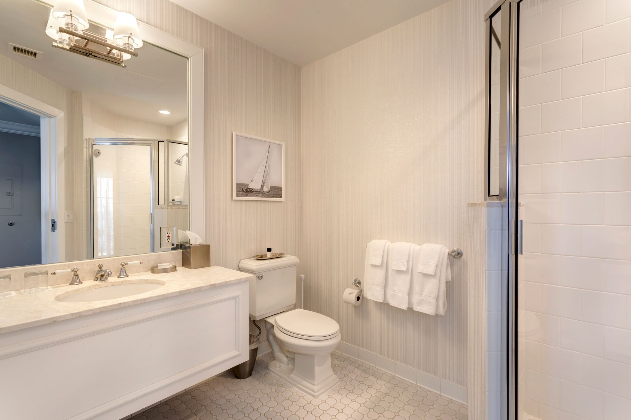 A bathroom showing vanity, toilet, and glass shower