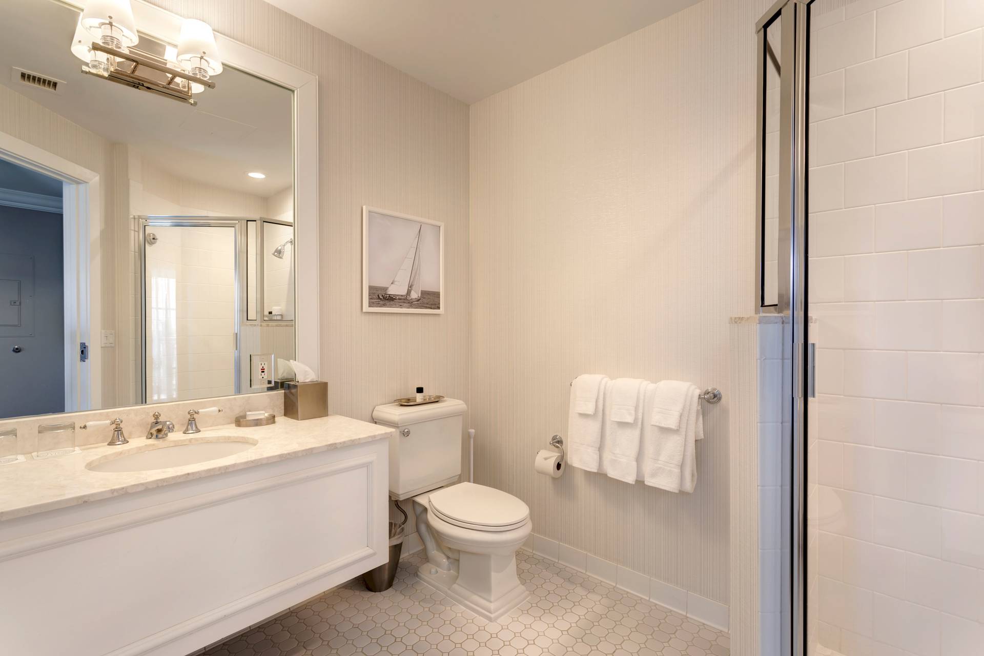 A bathroom showing vanity, toilet, and glass shower