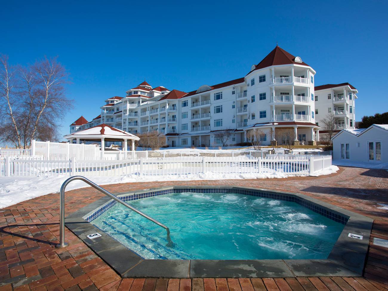 Bubbling blue hot tub near Inn at Bay Harbor on sunny winter day