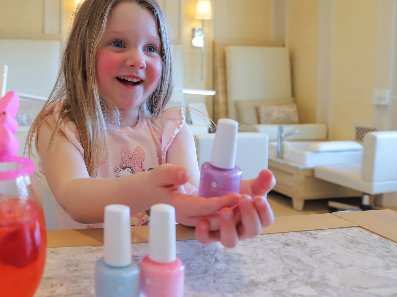 Young girl smiling with nail polish, The Spa