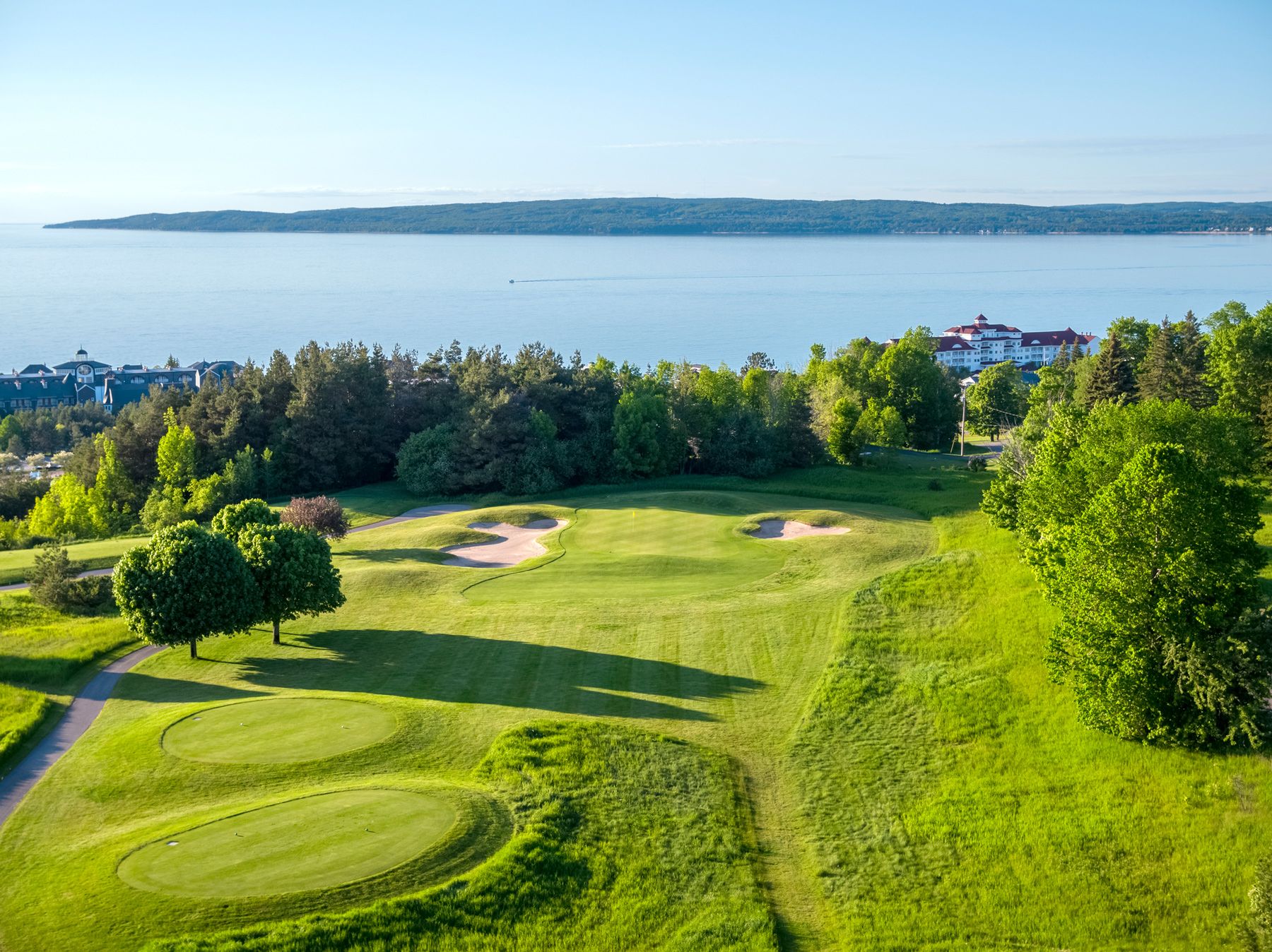 An elevated golf course view with the Inn at Bay Harbor in the background