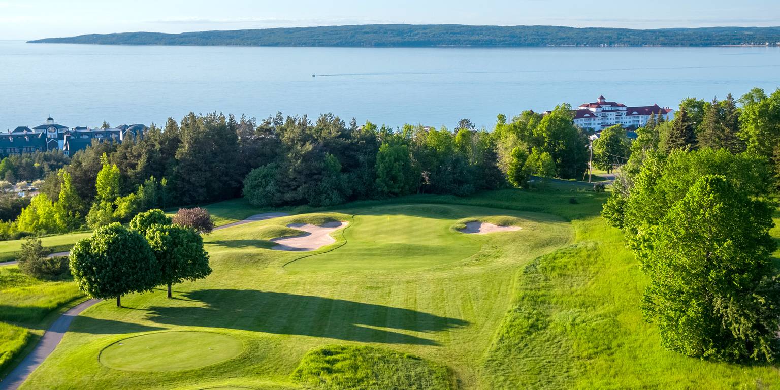 An elevated golf course view with the Inn at Bay Harbor in the background