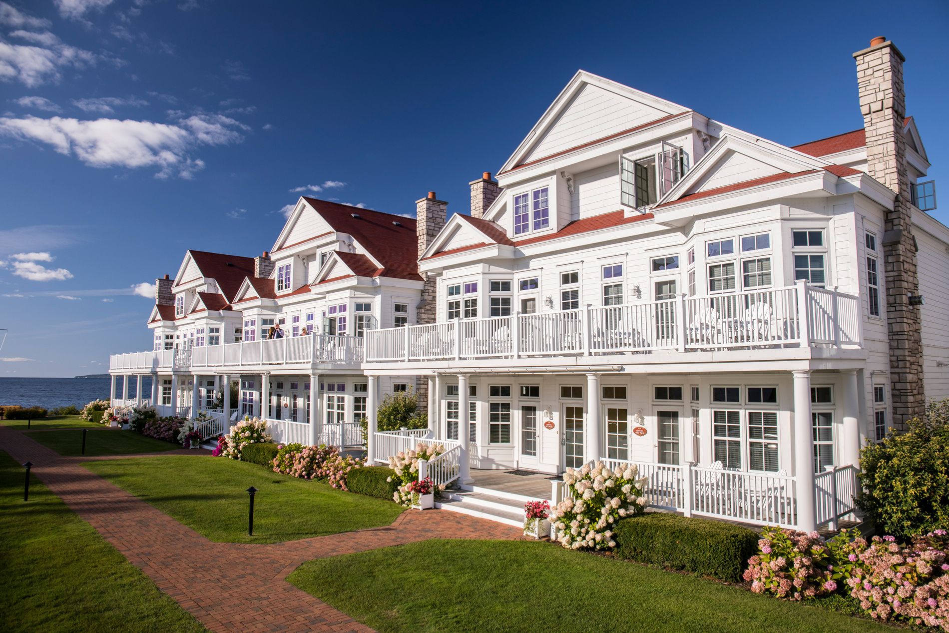 A row of Lakeside Cottages with beautiful rose bushes and paver sidewalks