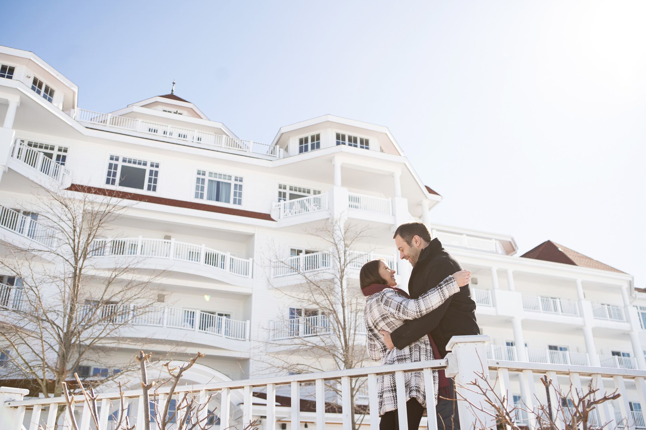 Couple embraces outside of Inn at Bay Harbor