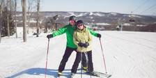 Smiling ski couple poses together, The Highlands ski area near Bay Harbor