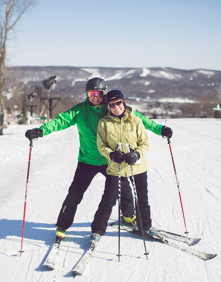 Ski couple smiles at camera, The Highlands