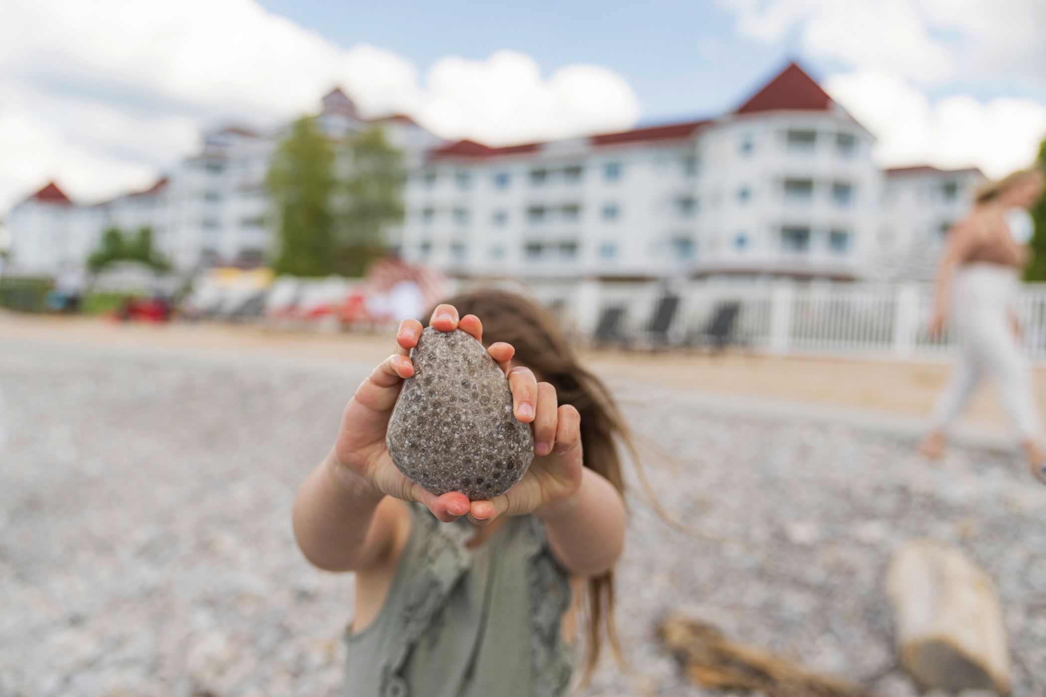 A young girl shows off a large Petoskey stone at the Inn at Bay Harbor