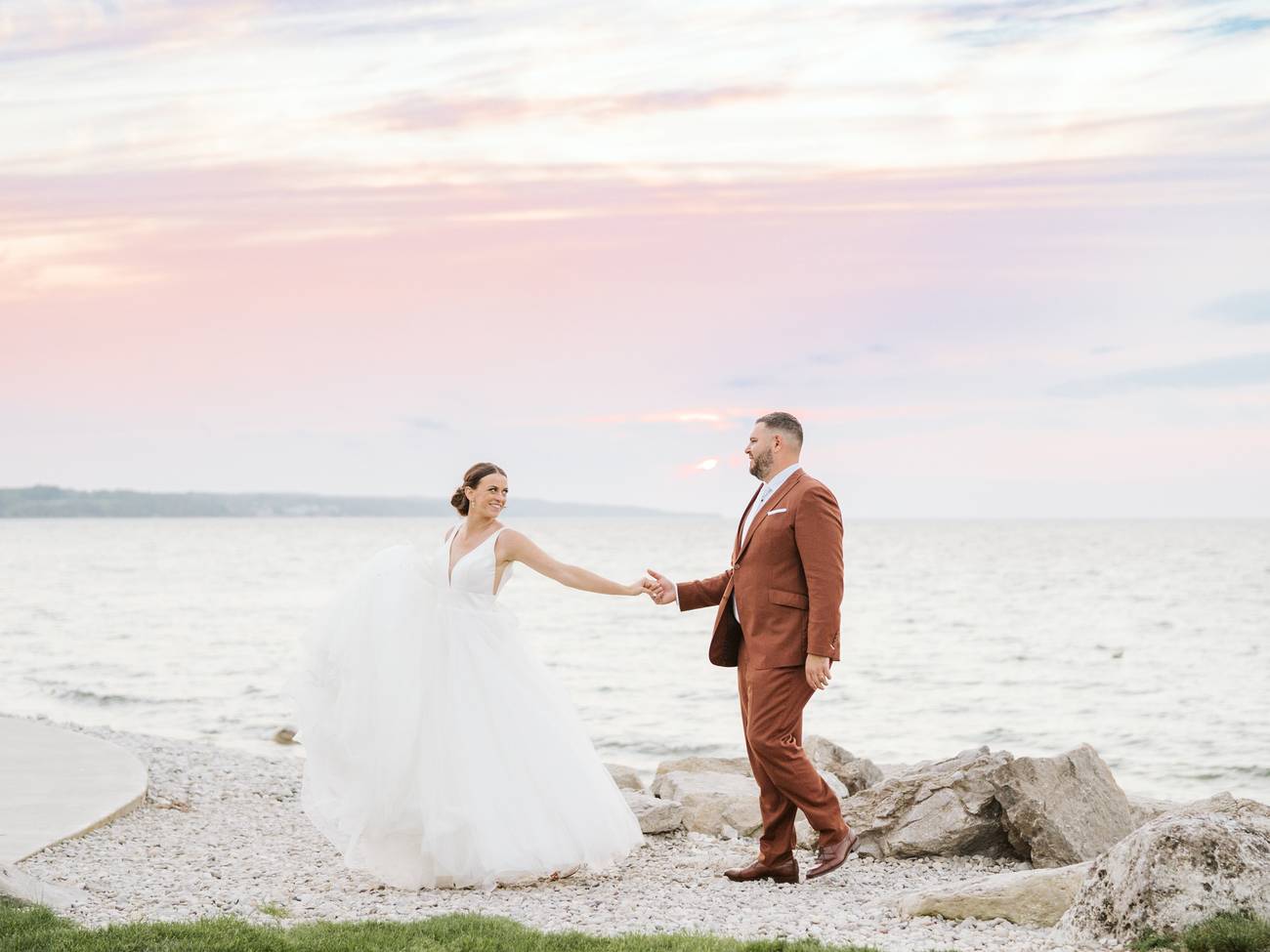 Newlywed couple with pink sunset over Lake Michigan, Inn at Bay Harbor