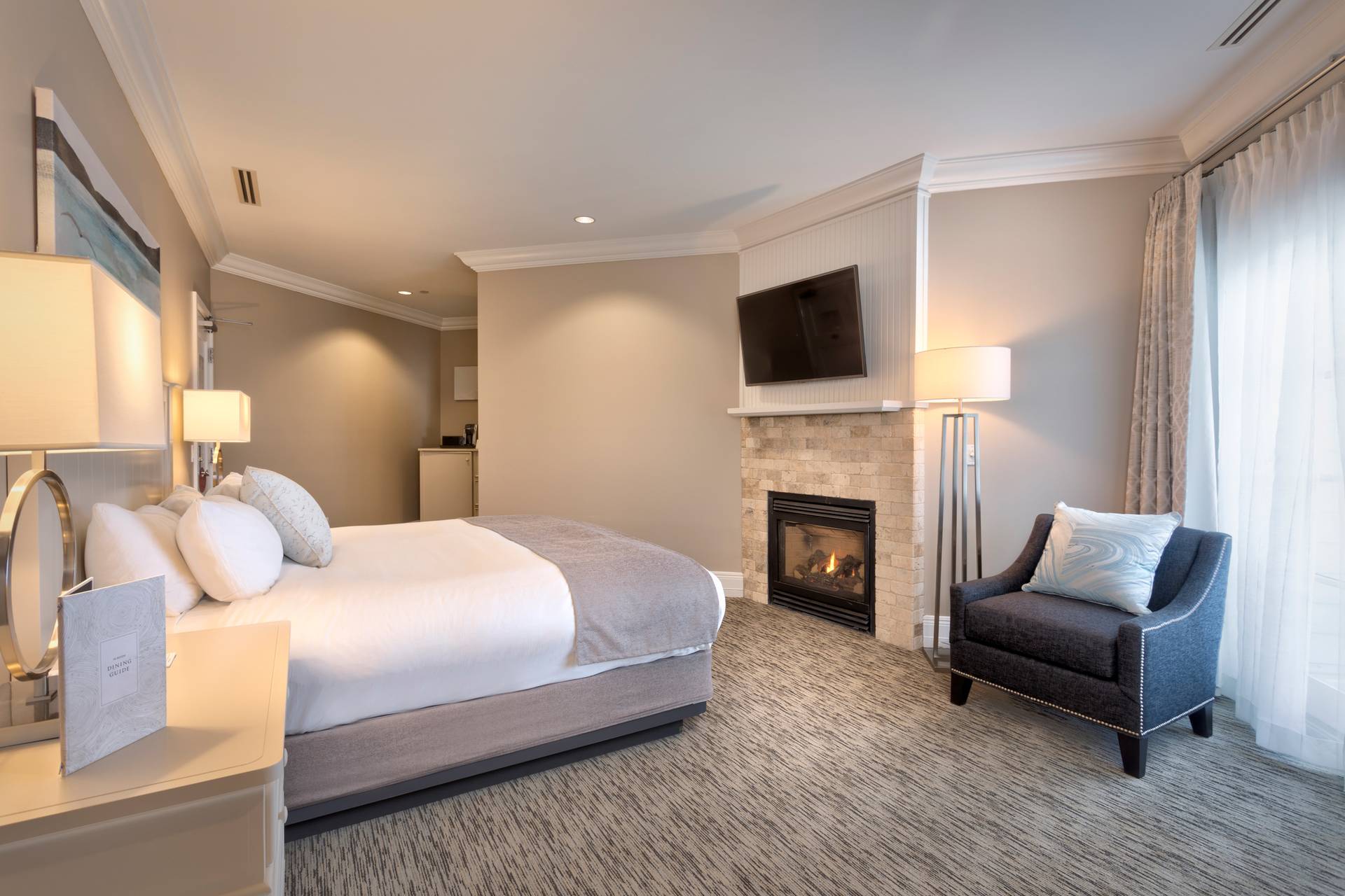 Tower King bed, fireplace, and chair details, Inn at Bay Harbor