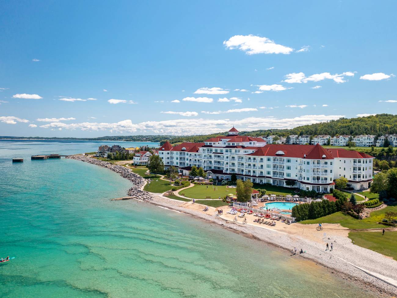 Summer drone view of the Inn at Bay Harbor with kayakers in the bay
