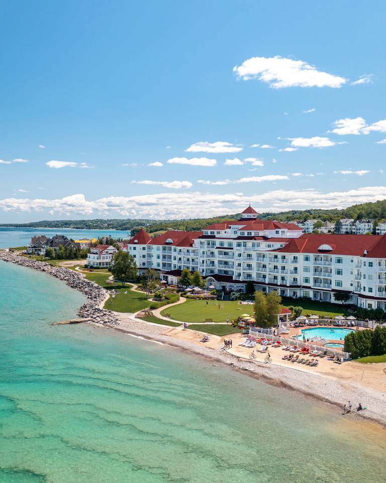 Summer drone view of the Inn at Bay Harbor with kayakers in the bay