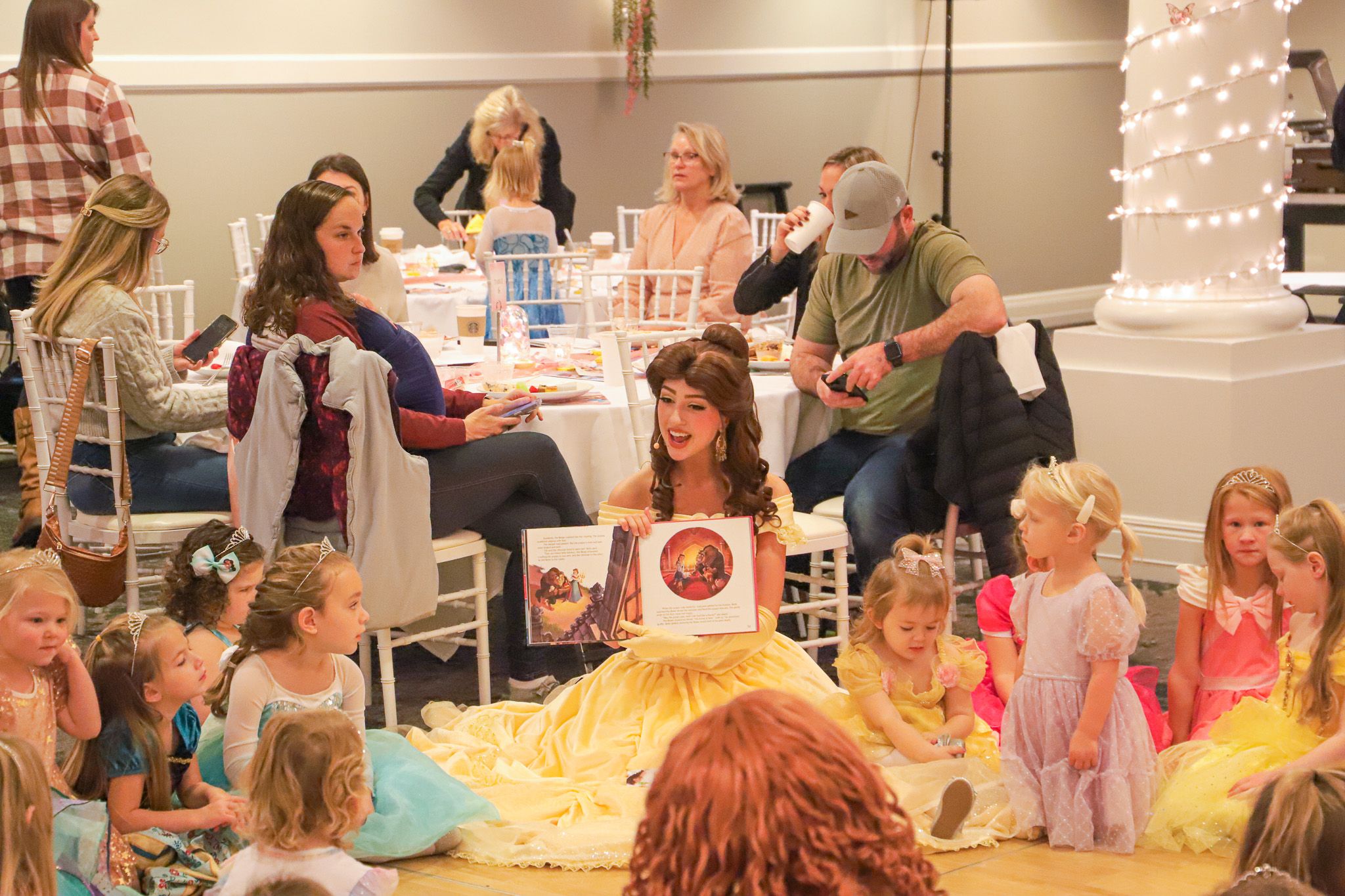 Belle character reads book to guests, Princess Gala, Inn at Bay Harbor