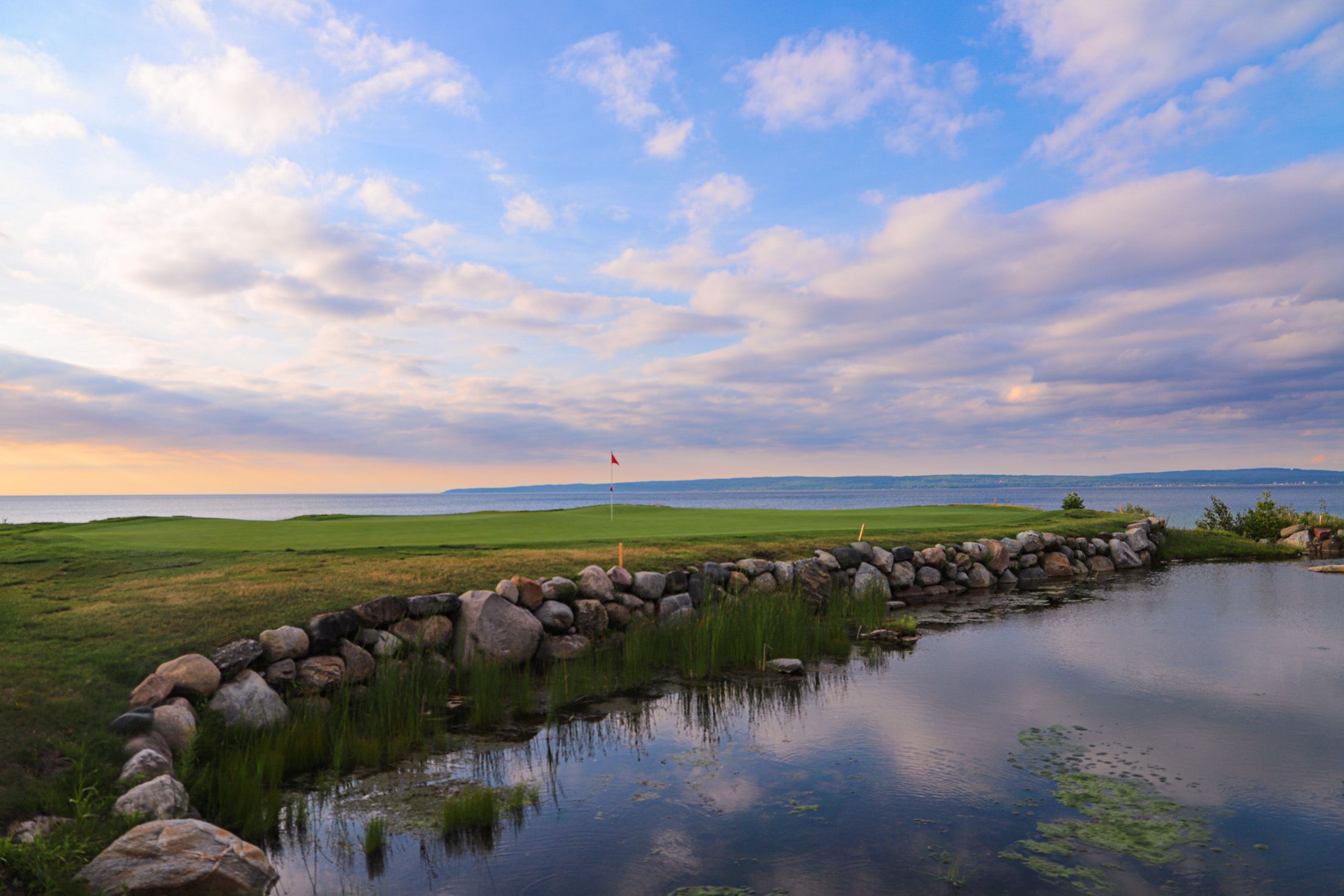 The Quarry 8 on Lake Michigan under orange sunset sky