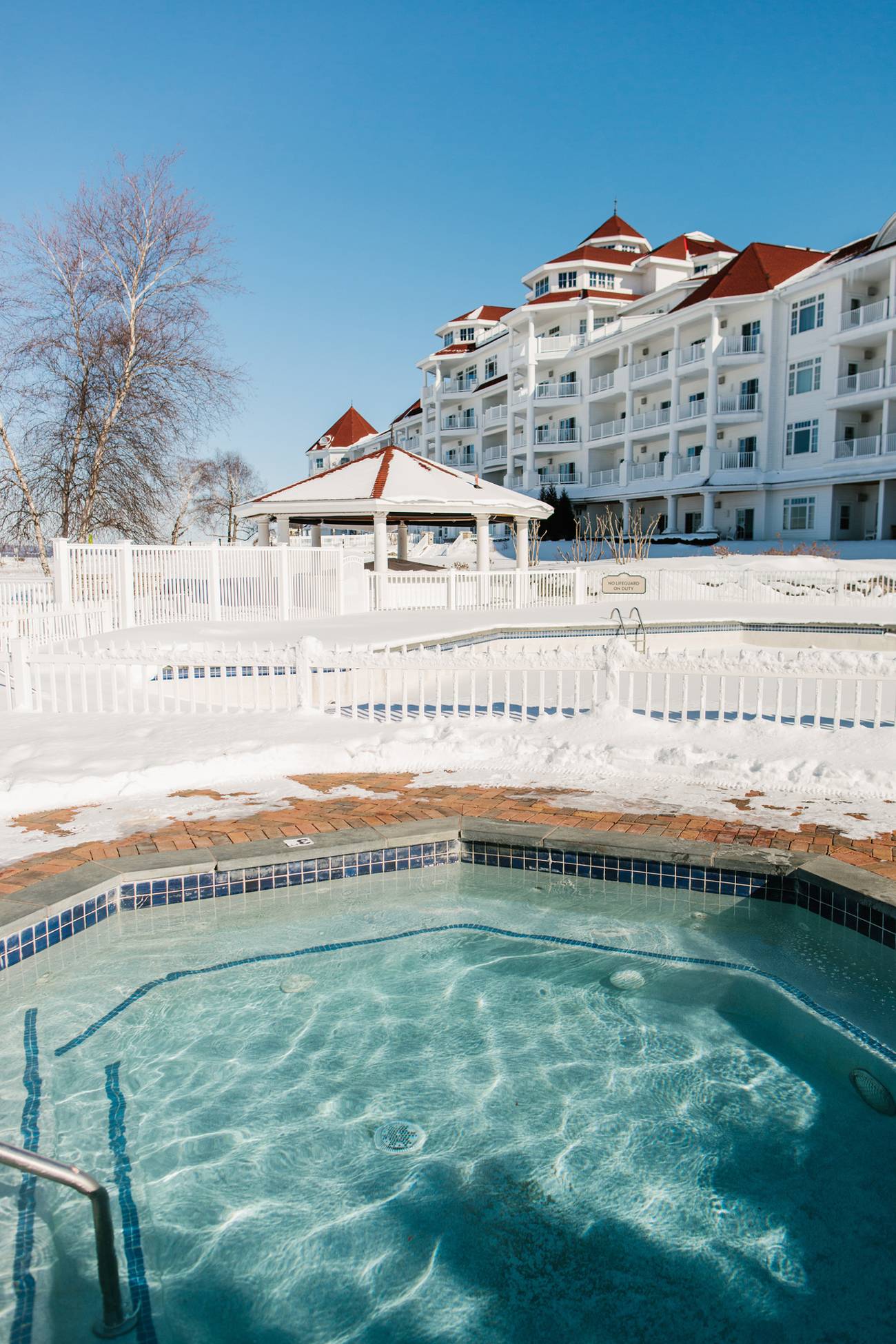 A hot tub view in the winter looking back at the Inn at Bay Harbor