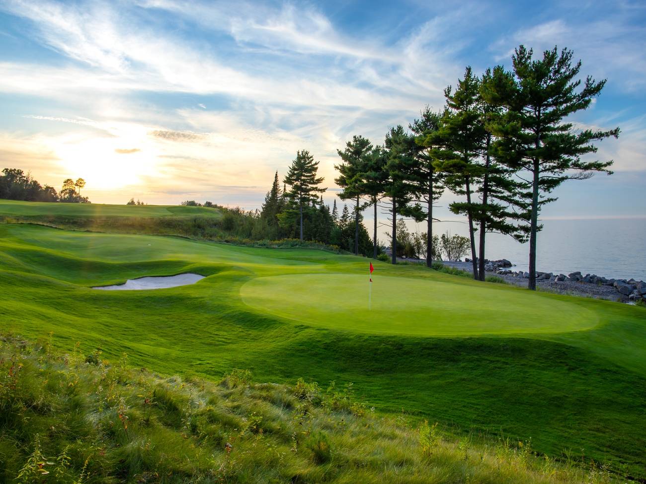 The Quarry course green, cedar trees on Lake Michigan at sunset
