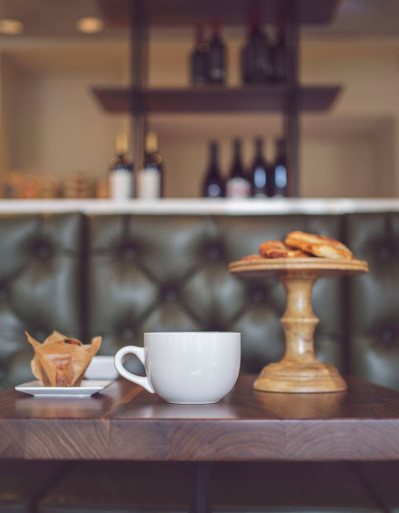 Coffee and pastries on a table with green seating