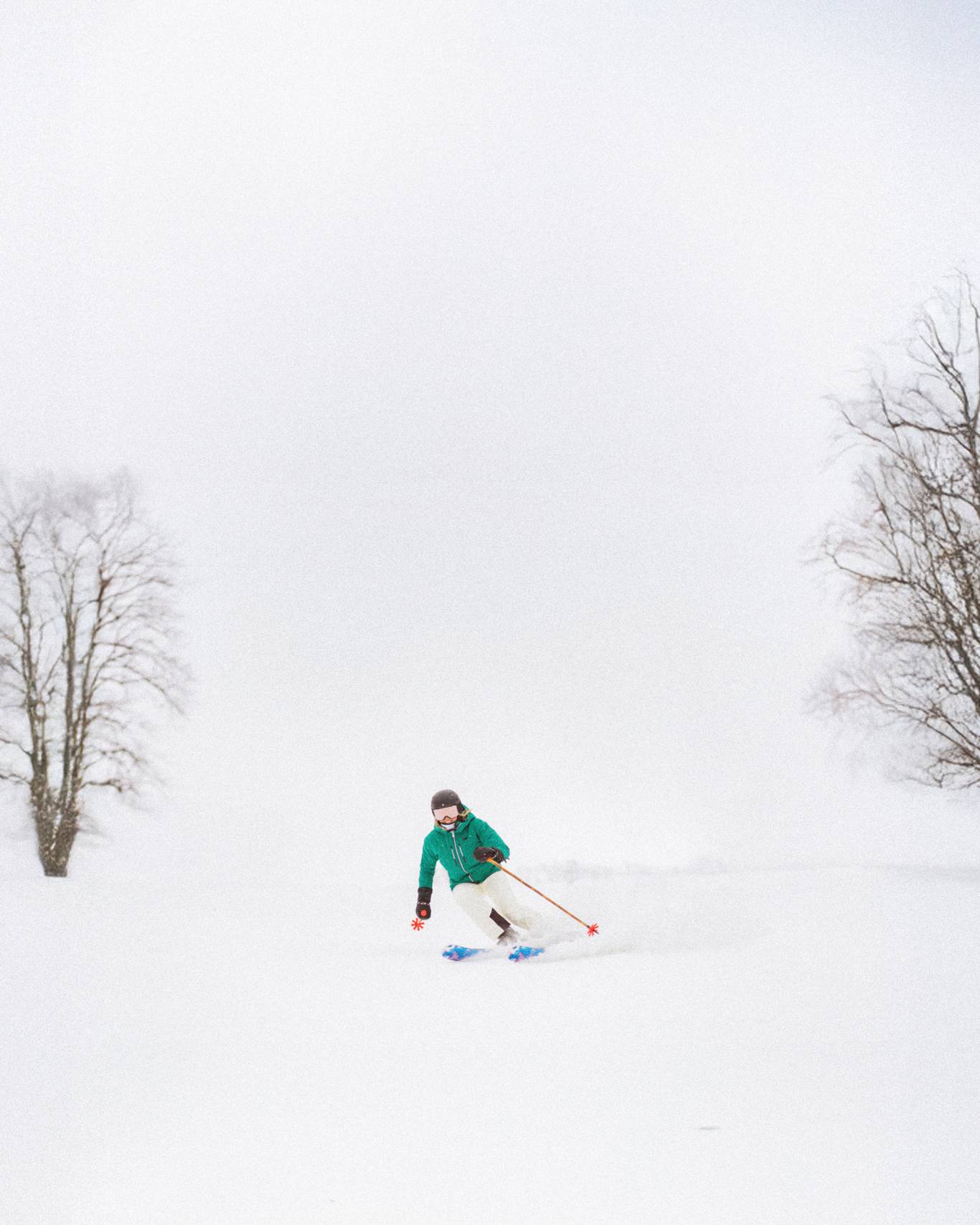 Skier on sunny snowy hill