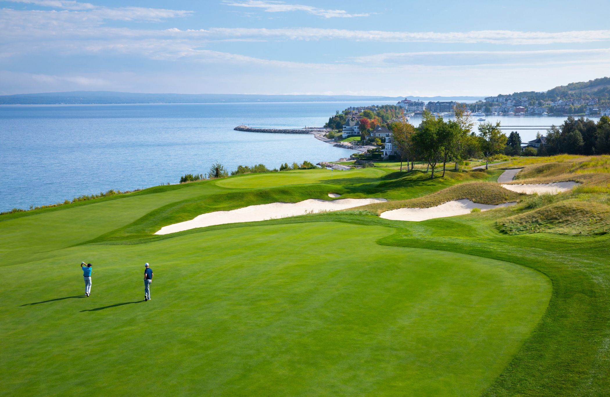Golfers on The Links course swinging toward Bay Harbor on Lake Michigan, Bay Harbor Golf Club
